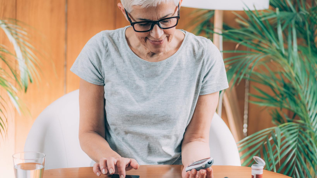 Woman using a continuous glucose monitor to manage diabetes with a focus on RPM.